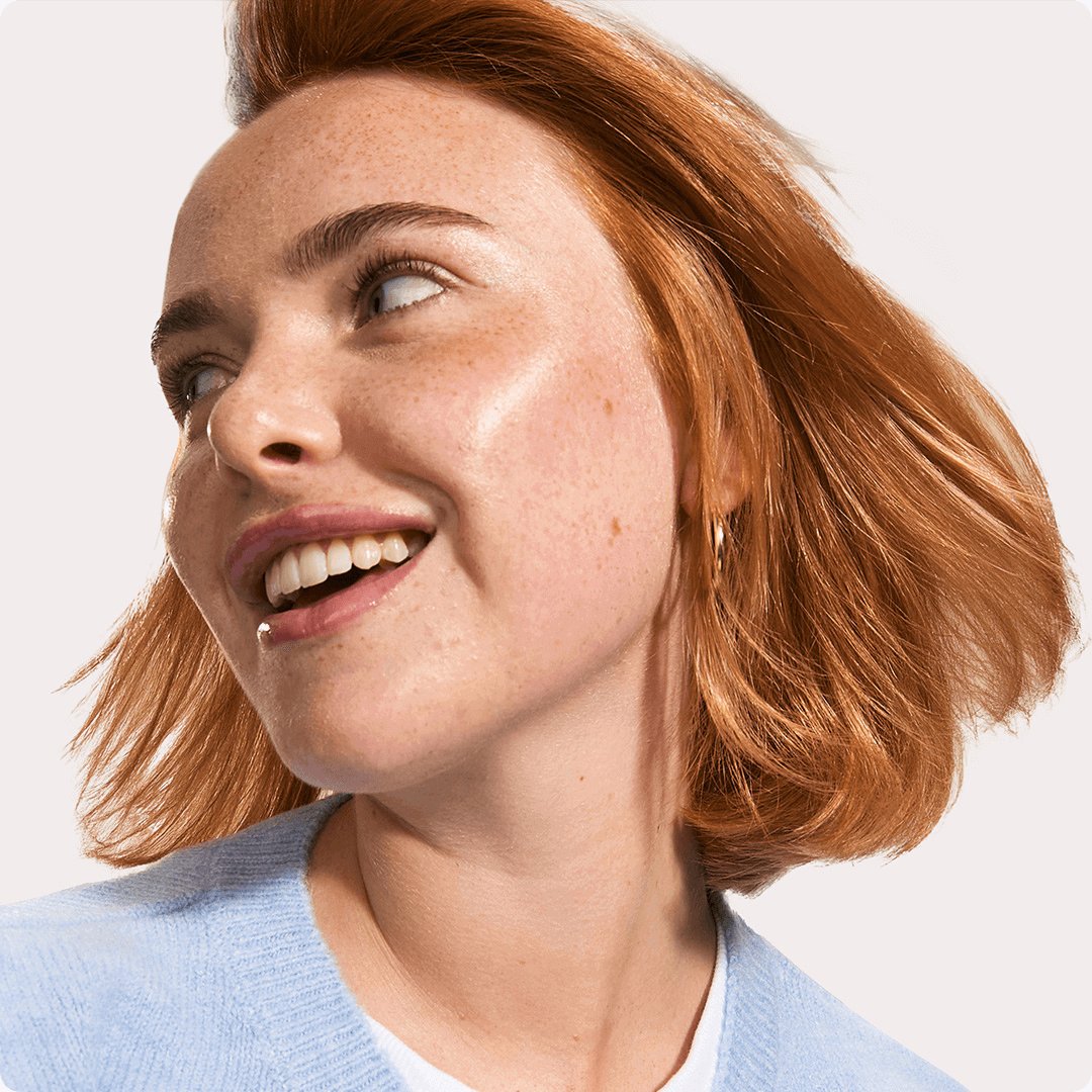 2025 consumer product division brand garnier woman in blue sweater and brown hair smiling