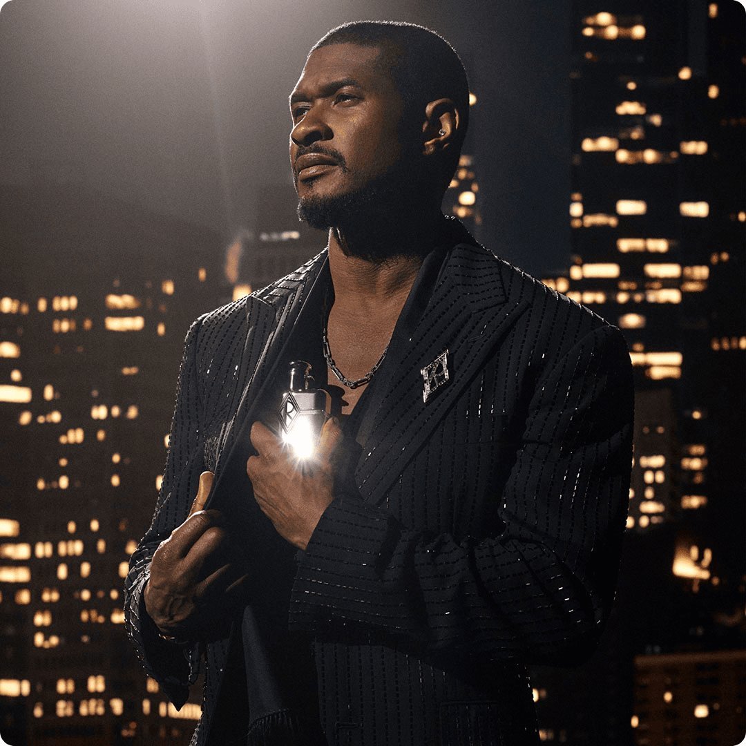 2025 ralph lauren fragrances luxe brand men black embellished suit holding a perfume grey bottle