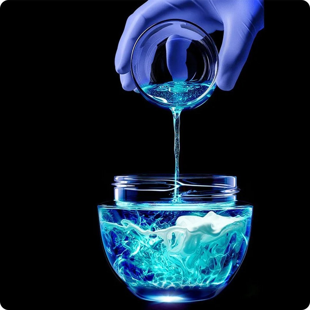 beauty full of science hand pouring blue scientific liquid kv desk