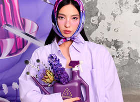 2026 consumer product division 3CE woman wearing purple shirt and scarf carrying flowers